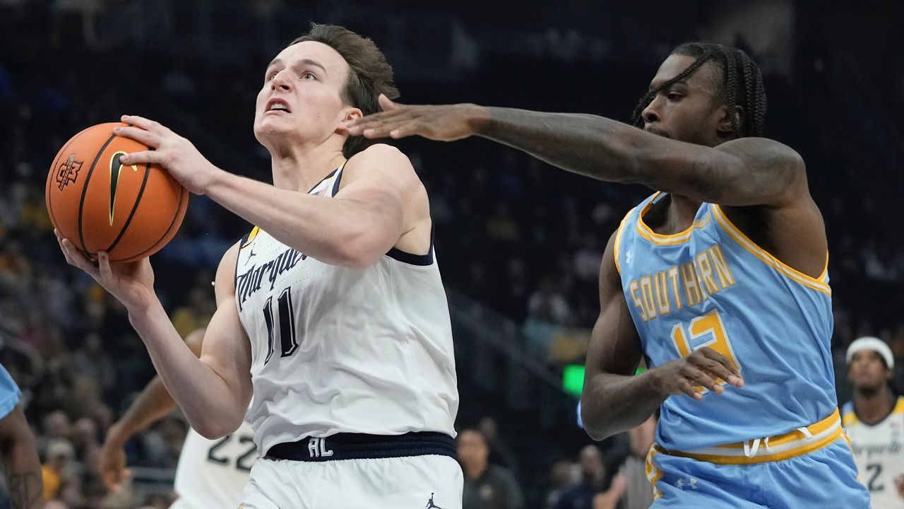 Marquette's Tyler Kolek drives past Southern's Dre'Shawn Allen during the first half of an NCAA college basketball game