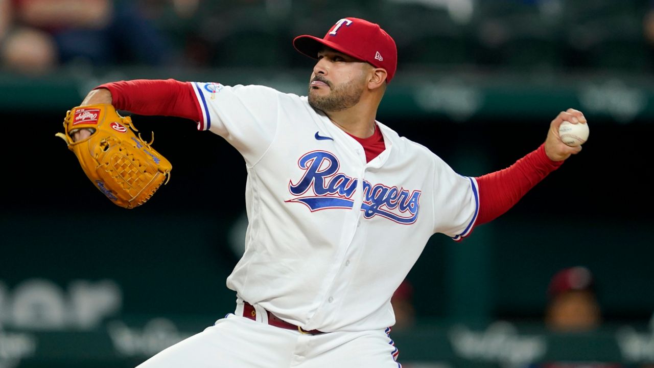 Texas Rangers starting pitcher Martin Perez throws to the Philadelphia Phillies in the first inning of a baseball game, Tuesday, June 21, 2022, in Arlington, Texas. (AP Photo/Tony Gutierrez)