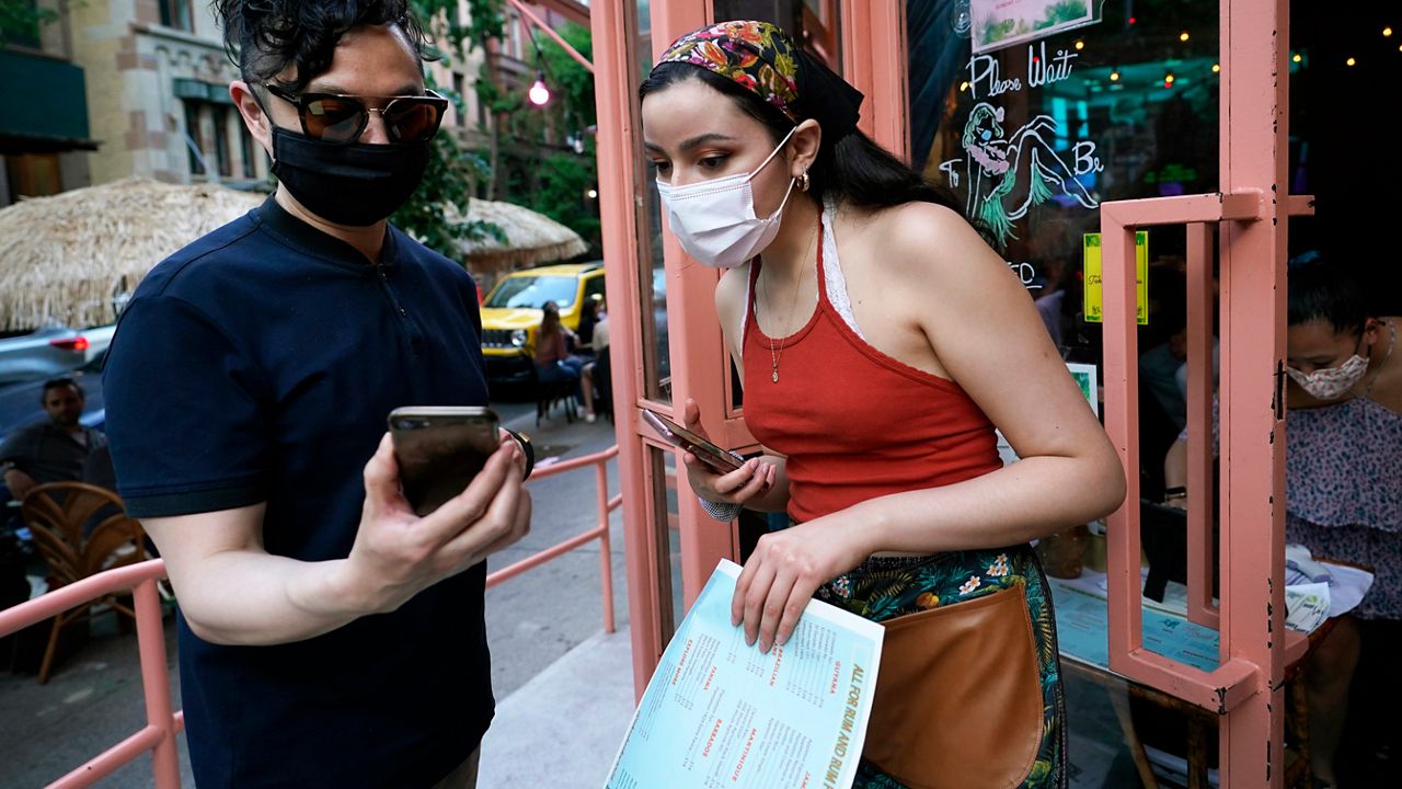 People appear with facial masks in this file image. (Spectrum News/FILE)