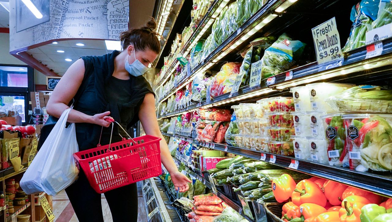 A shopper in New York City. May 14, 2021. (AP Photo/John Minchillo)