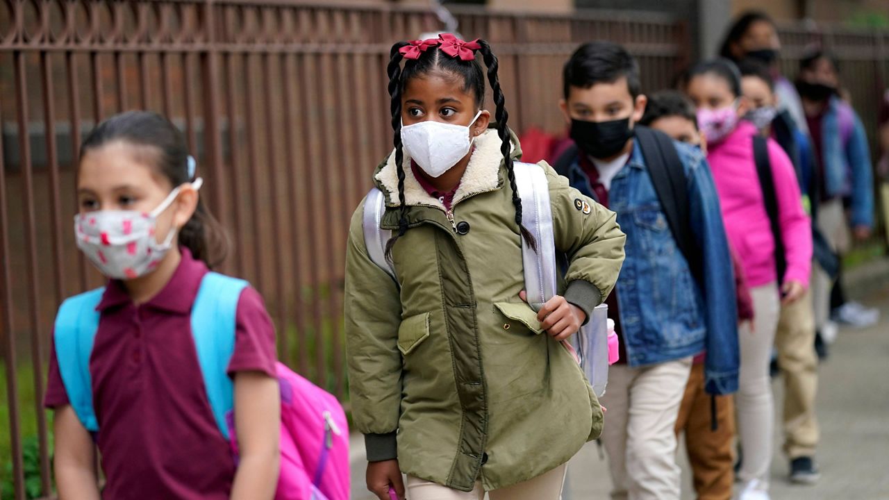 FILE - Students line up to enter Christa McAuliffe School in Jersey City, N.J., on April 29, 2021.(AP Photo/Seth Wenig, File) 