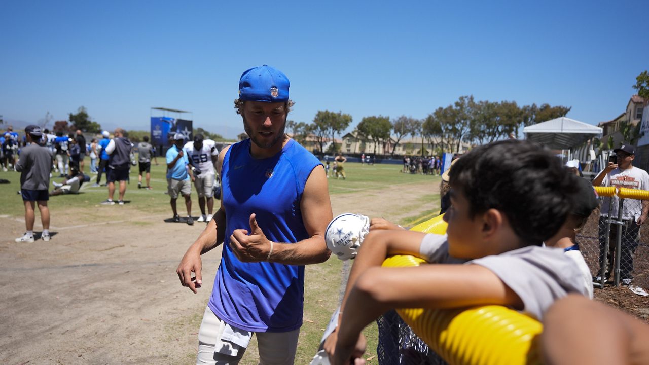 Los Angeles Rams quarterback Matthew Stafford signs autographs after a joint NFL football practice with the Dallas Cowboys, Wednesday, Aug. 14, 2024, in Oxnard, Calif. (AP Photo/Ryan Sun)