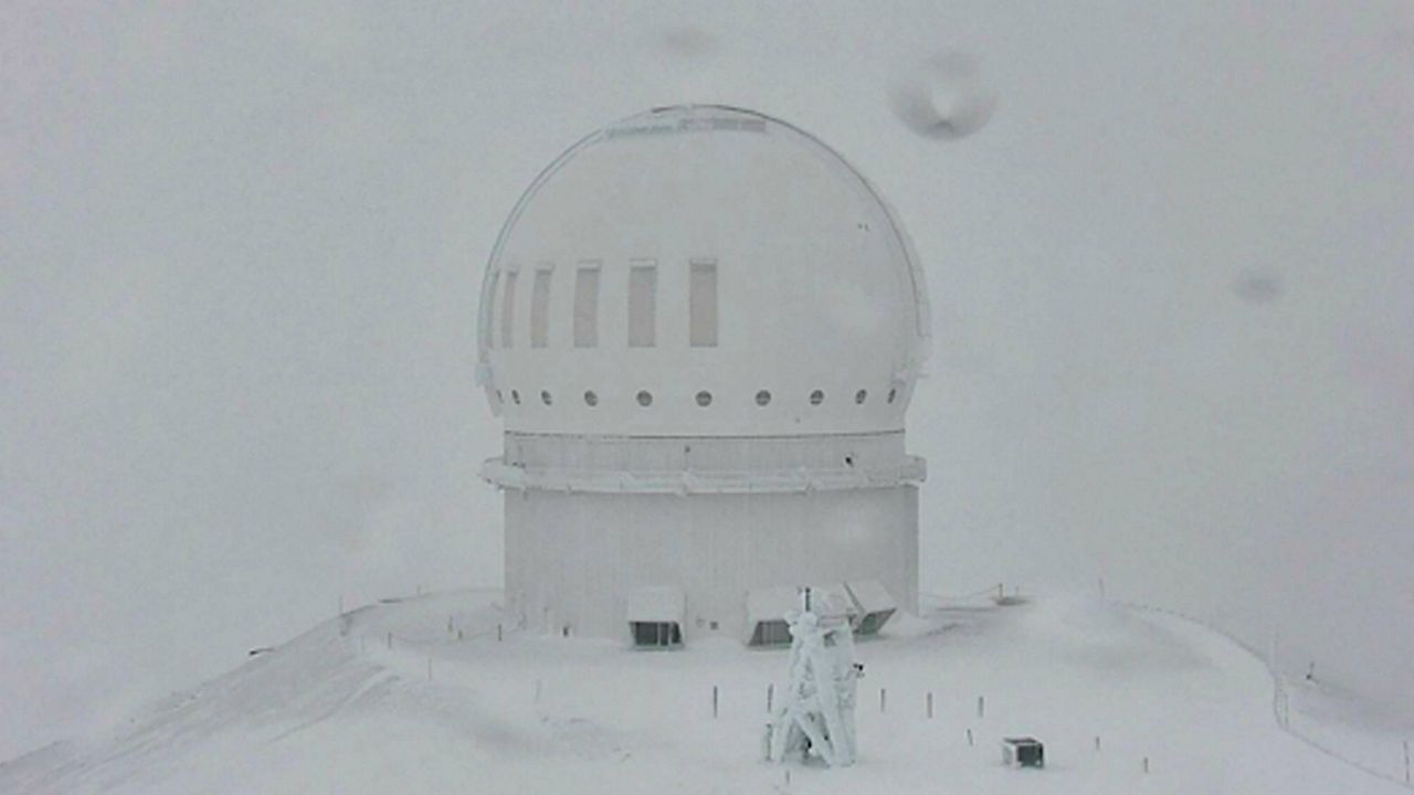 In this webcam image provided by the Canada-France-Hawaiʻi Telescope, snow is seen atop the summit of Mauna Kea in Hawaii on Monday, Dec. 6, 2021. (Canada-France-Hawaiʻi Telescope via AP)