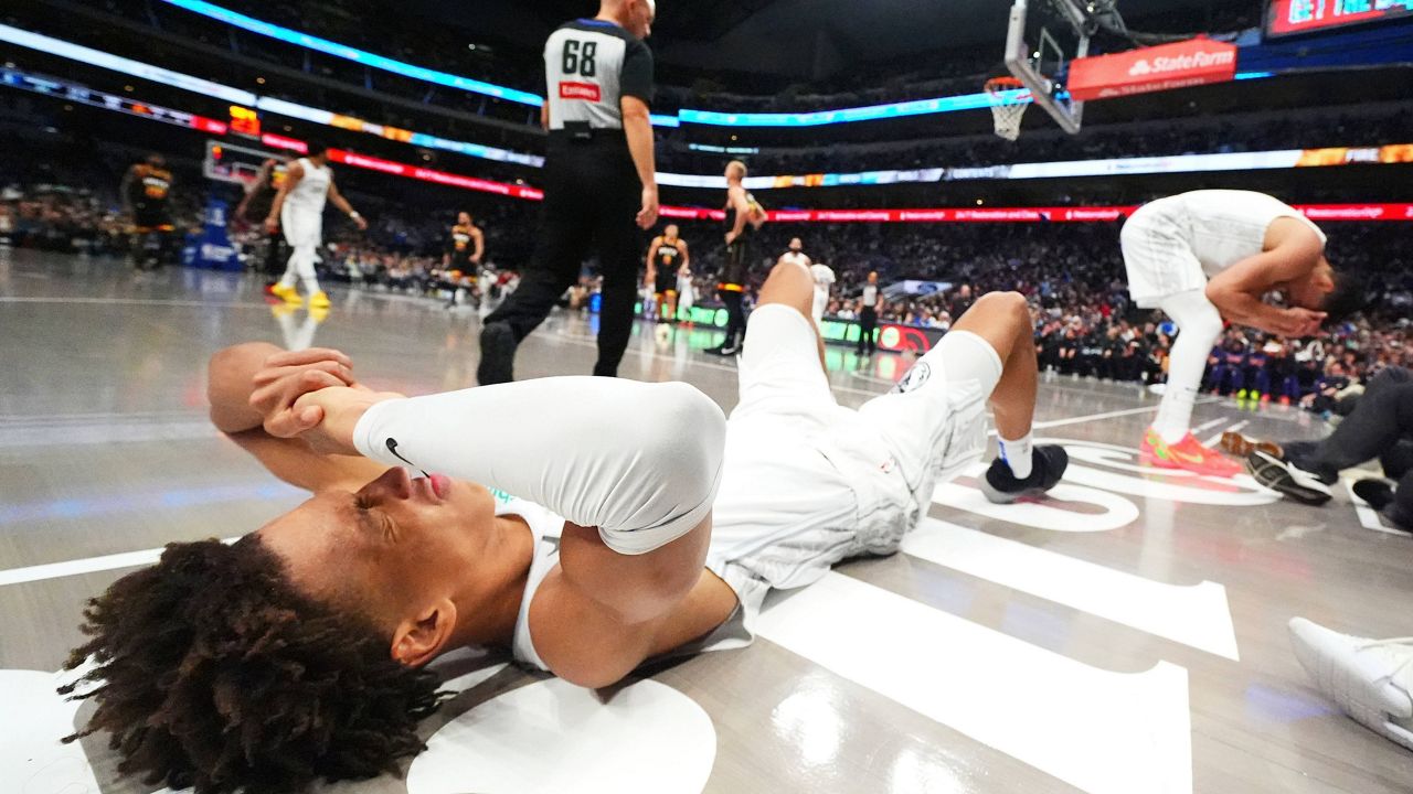 Dallas Mavericks forward Kessler Edwards, left, and center Dwight Powell react after colliding while chasing a rebound against the Phoenix Suns during the second half of an NBA basketball game Sunday, March 9, 2025, in Dallas. (AP Photo/Julio Cortez)