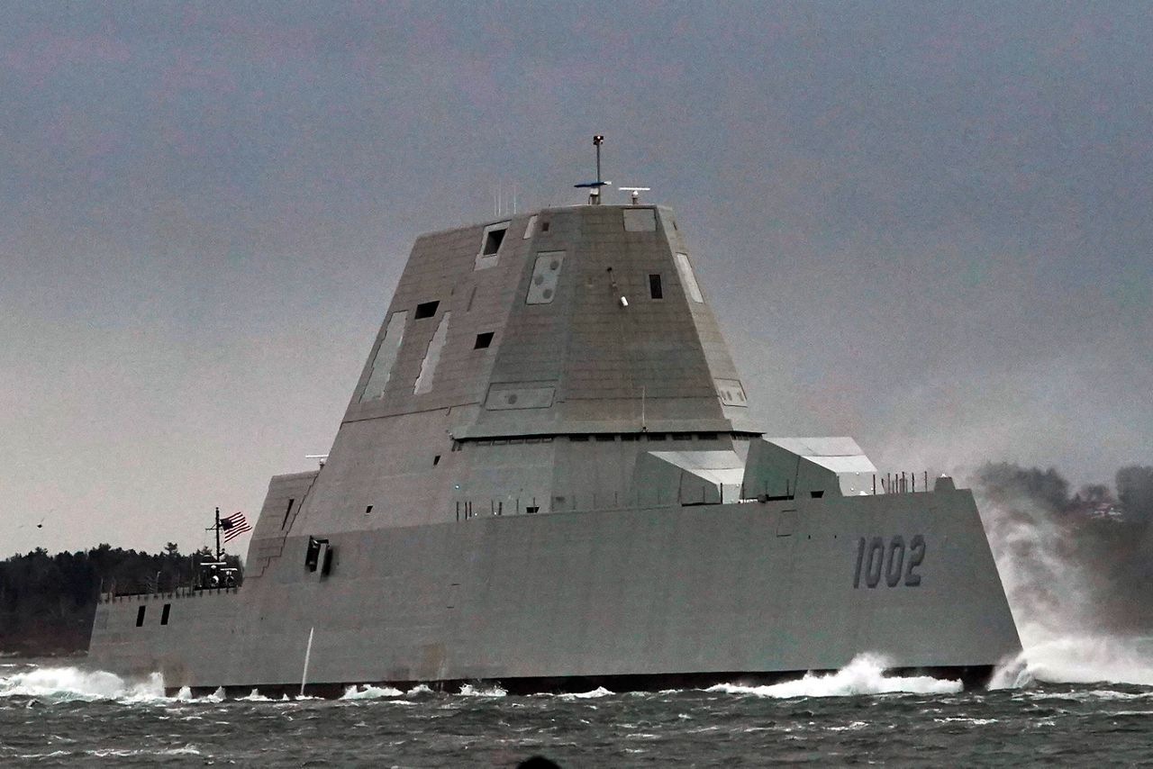The Lyndon B. Johnson travels down the Kennebec River on its way to sea, in this Wednesday, Jan. 12, 2022, file photo, in Phippsburg, Maine. The Navy's largest and most expensive destroyers were built around a new gun system that could rapidly fire GPS-guided projectiles more than 50 miles, paving the way for the Marines to storm ashore. But those weapons, rendered useless without ammo, are going to be removed without ever firing a single shot as the Navy rushes to replace them with hypersonic weapons. (Photo by Robert F. Bukaty/Associated Press).