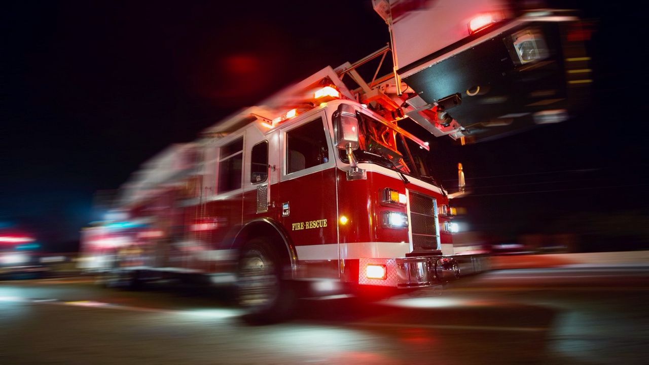 A fire truck driving down a road. (File Photo)