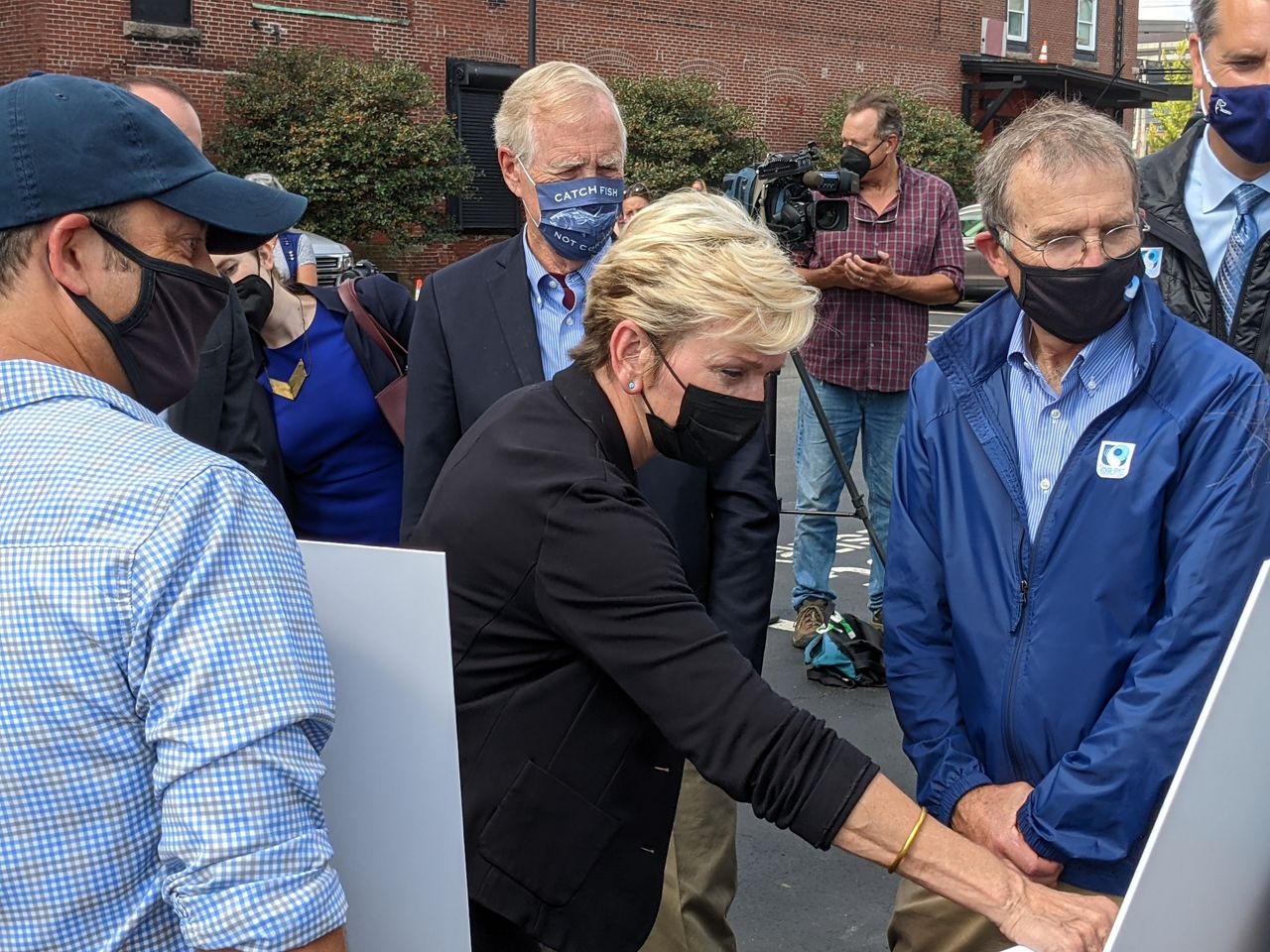 U.S. Energy Secretary Jennifer Granholm visits marine energy developer ORPC in Portland Friday, with Maine Sen. Angus King, in back, and ORPC president John Ferland, at right.