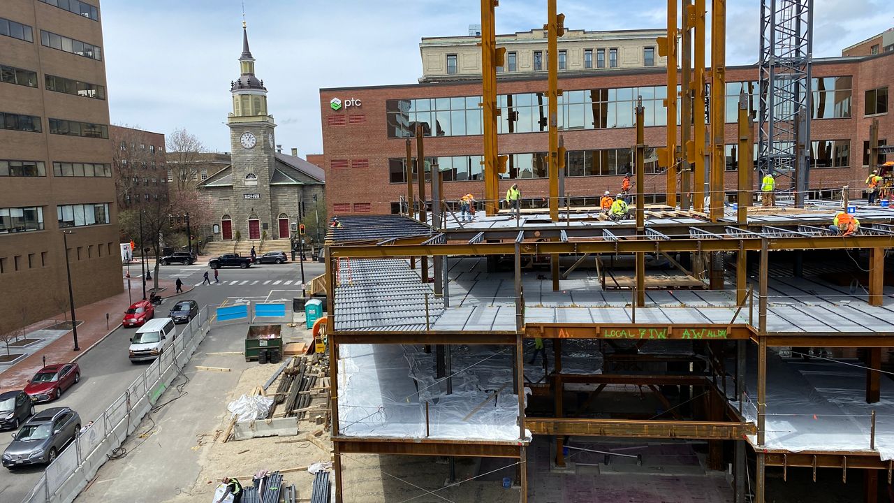 Builders work on an 18-story apartment building at 200 Federal Street in downtown Portland in April. Changes to the city's inclusionary zoning clause mean large-scale projects like this may be fewer and farther between going forward. (Photo by Sean Murphy/Spectrum News Maine).