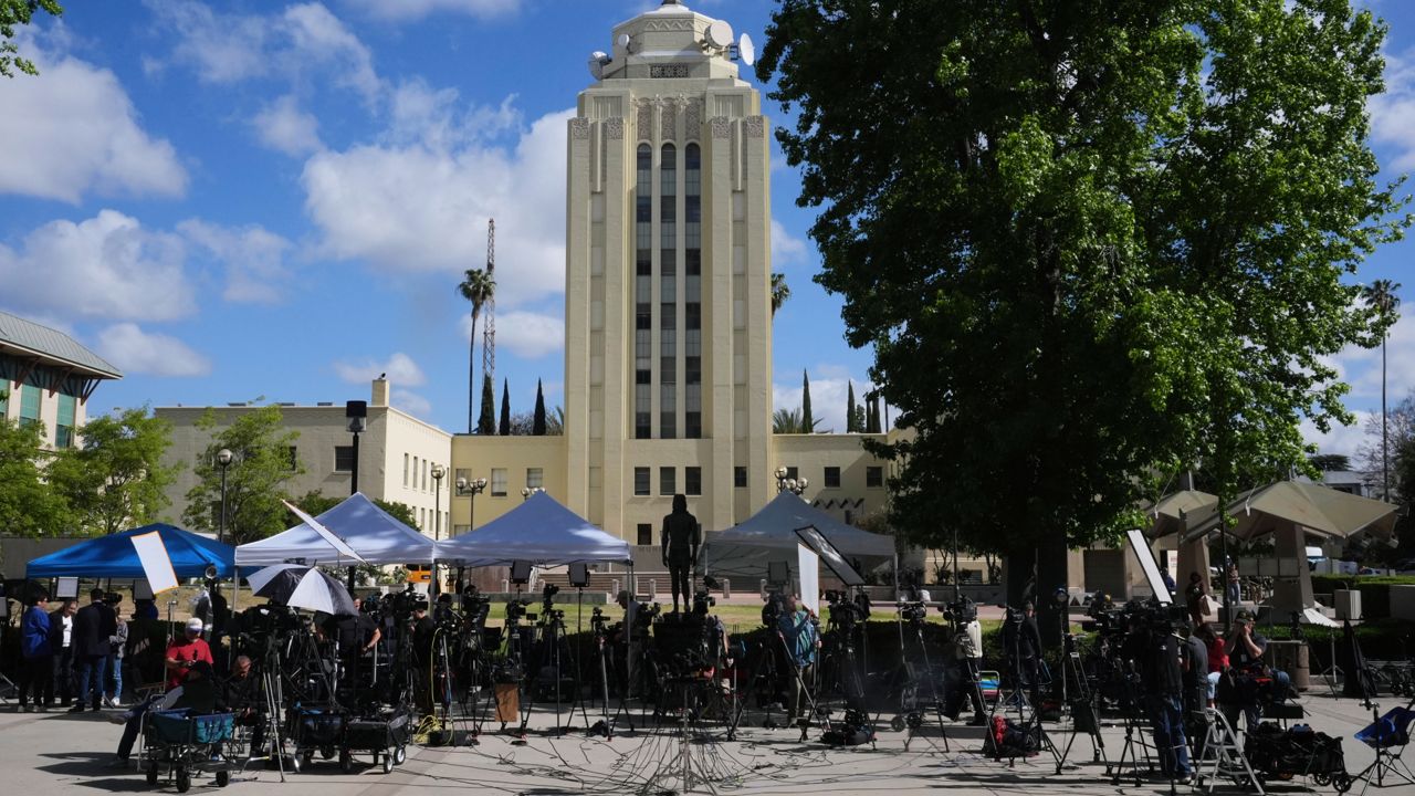 Media stage outside the Van Nuys Courthouse for a hearing in the case of Erik and Lyle Menendez on Tuesday in Los Angeles. (AP Photo/Damian Dovarganes)