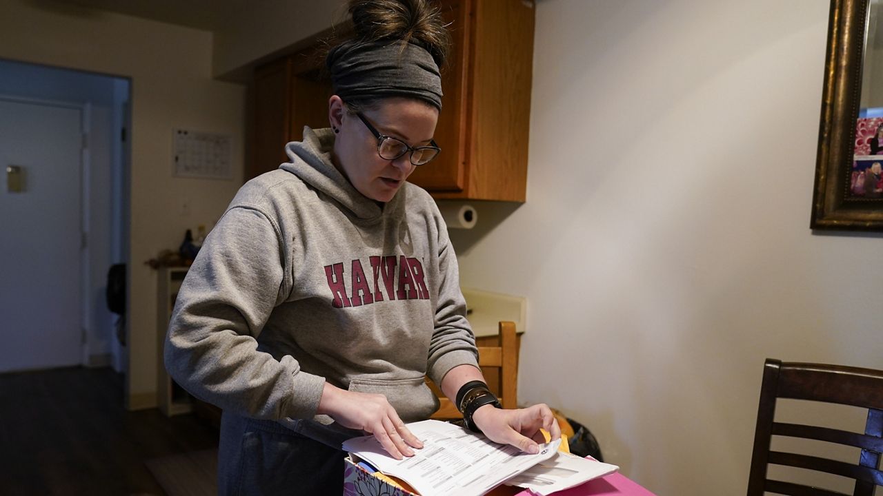 Samantha Richards looks over her Medicaid papers on June 9 in Bloomington, Ind. (AP Photo/Darron Cummings)