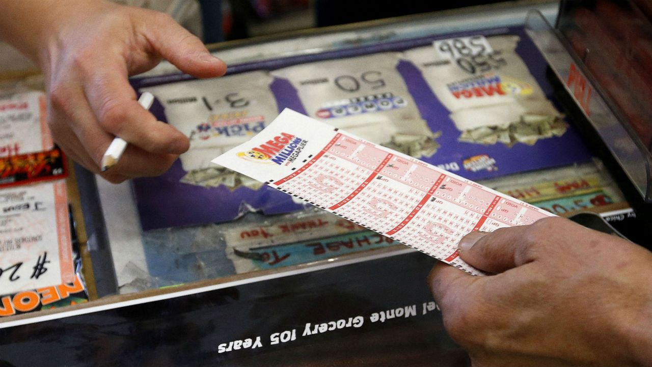 A lottery ticket transaction between a cashier and customer. (AP)
