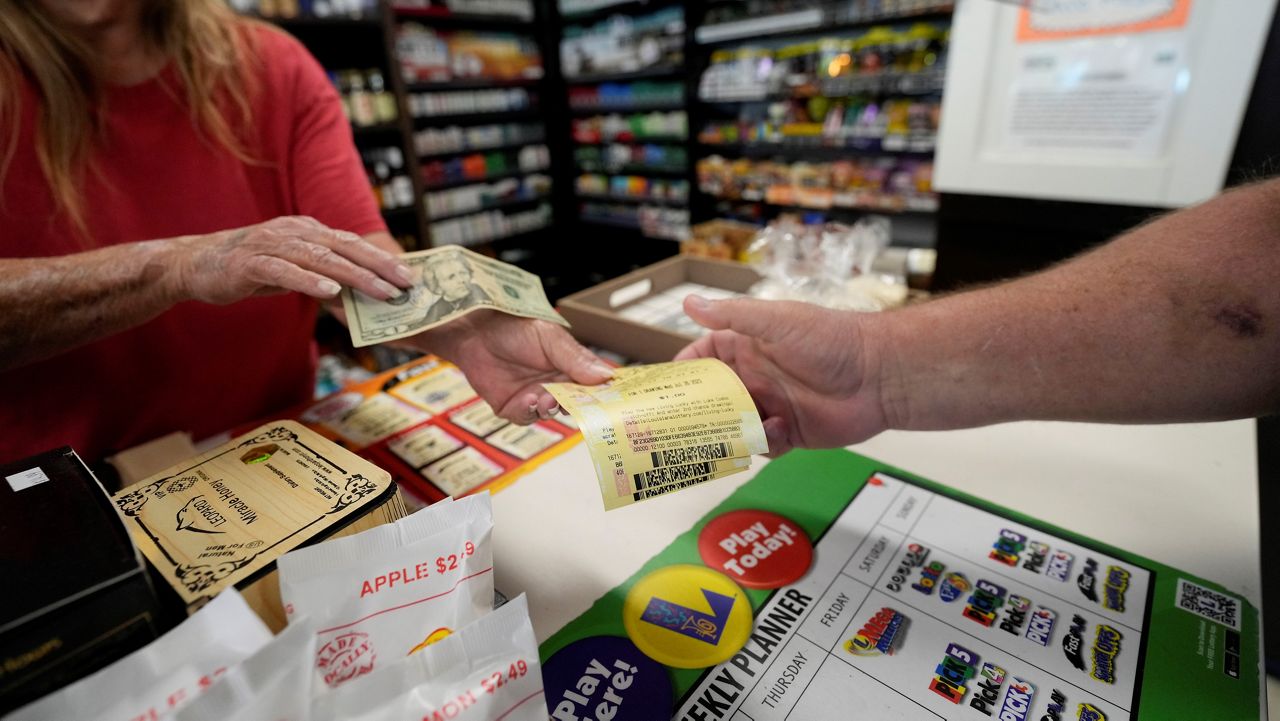 Cashier Rosemary Probst sells tickets for the Mega Millions lottery at the Save 'N Time convenience store in Harahan, La., Wednesday, July 26, 2023. (AP Photo/Gerald Herbert)