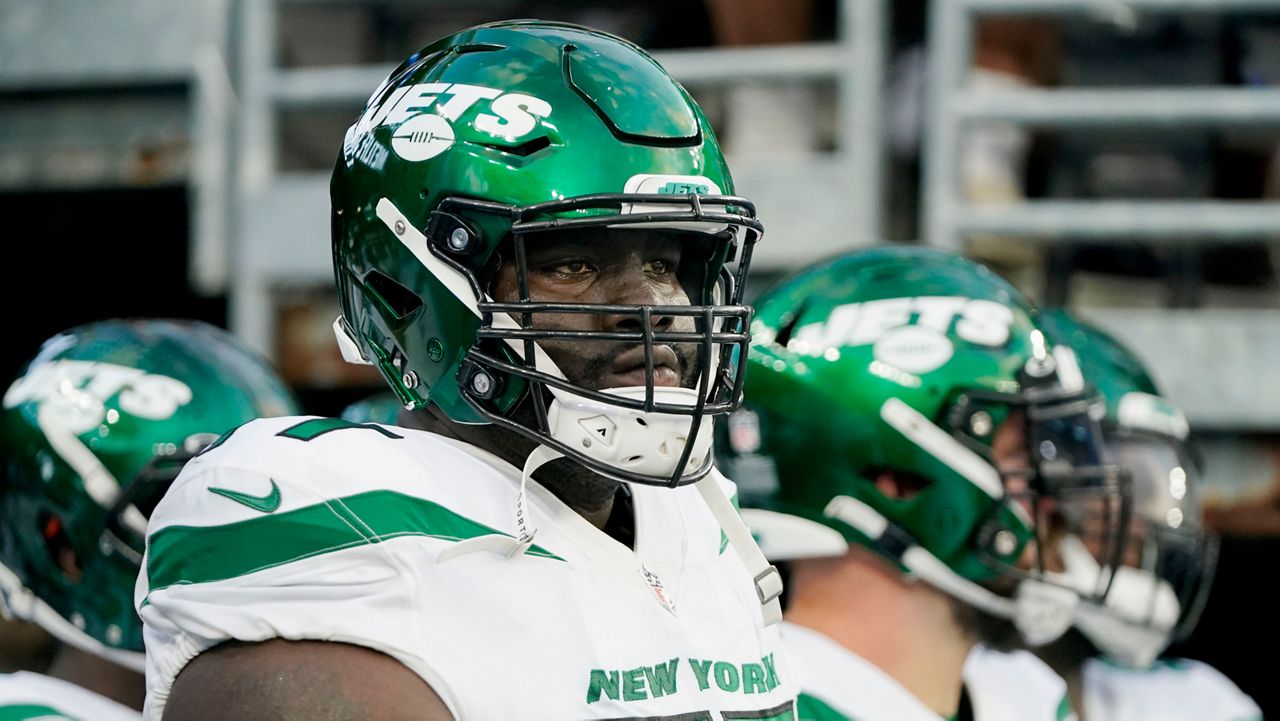 New York Jets offensive tackle Mekhi Becton waits to take the field before an NFL preseason football game against the New York Giants, Aug. 14, 2021, in East Rutherford, N.J. The New York Jets declined the fifth-year option on offensive tackle Becton’s contract, according to a person familiar with the decision. It was an expected choice by the Jets, who had until Tuesday, May 2, 2023, afternoon to pick up the option if they chose to do so. (AP Photo/Frank Franklin II)