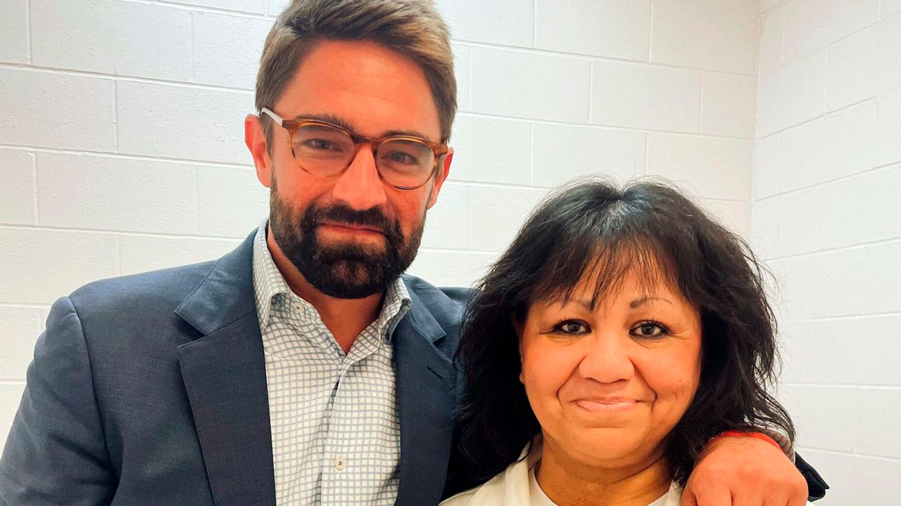 In this April 6, 2022 photo provided by Texas state Rep. Jeff Leach, Rep. Leach stands next to death row inmate Melissa Lucio during a visit by a group of seven lawmakers to the Mountain View Unit in Gatesville, Texas.