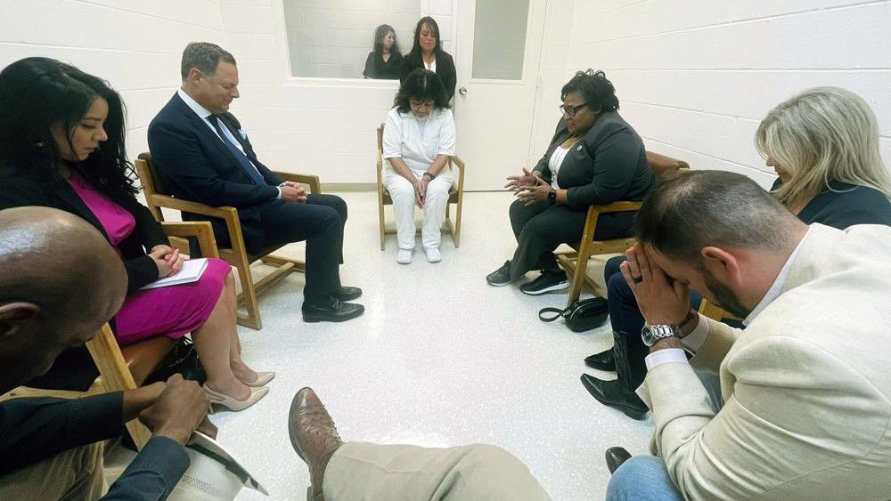 In this April 6, 2022 photo provided by Texas state Rep. Jeff Leach, Texas death row inmate Melissa Lucio, dressed in white, leads a group of seven Texas lawmakers in prayer in a room at the Mountain View Unit in Gatesville, Texas. The lawmakers visited Lucio to update her about their efforts to stop her April 27 execution. The lawmakers say they are troubled by Lucio’s case and believe her execution should be stopped as there are legitimate questions about whether she is guilty. (Texas state Rep. Jeff Leach via AP)