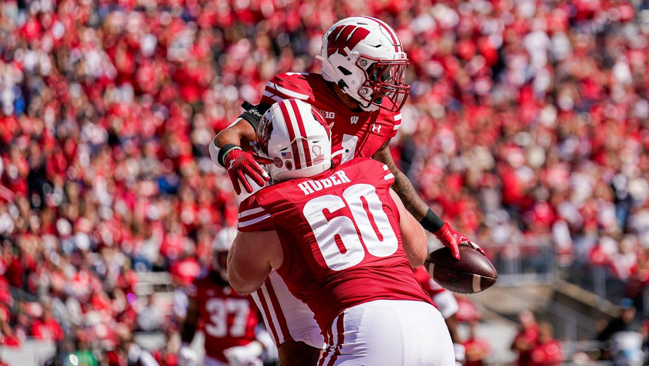 Wisconsin offensive lineman Joe Huber (60) congratulates running back Chez Mellusi