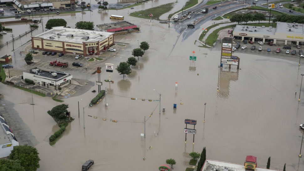A shopping center located at Texas 80 near I-35 has high water in the parking lots from the Blanco River flooding in San Marcos,Texas, on Sunday, May 24, 2015. Rodolfo Gonzalez/Austin American-Statesman via AP