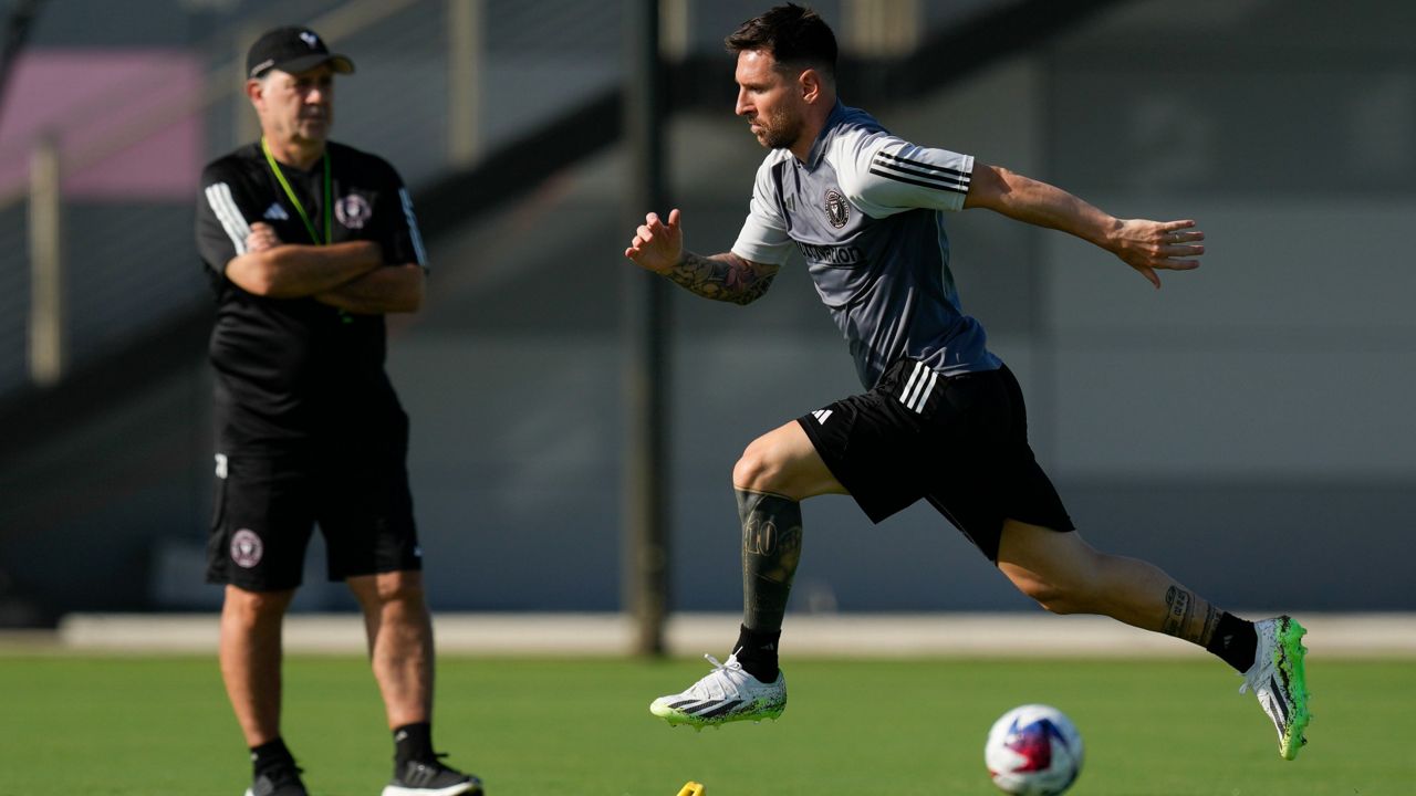 Lionel Messi, right, participates in his 1st training session for the Inter Miami MLS soccer team as coach Gerardo 'Tata' Martino looks on July 18, 2023 in Fort Lauderdale, Fla. (AP Photo/Rebecca Blackwell)