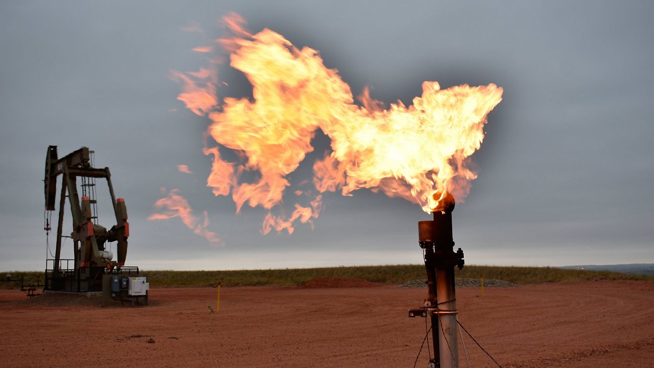 A flare burns natural gas at an oil well on Aug. 26, 2021, in Watford City, N.D. (AP Photo/Matthew Brown, File)