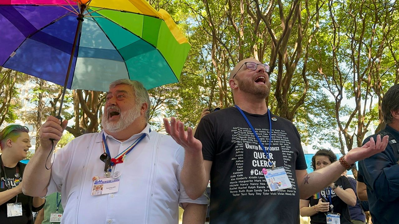 The Rev. David Meredith, left, and the Rev. Austin Adkinson sing during a gathering of those in the LGBTQ community and their supporters outside the Charlotte Convention Center, in Charlotte, N.C., Thursday, May 2, 2024. (AP File Photo/Peter Smith)
