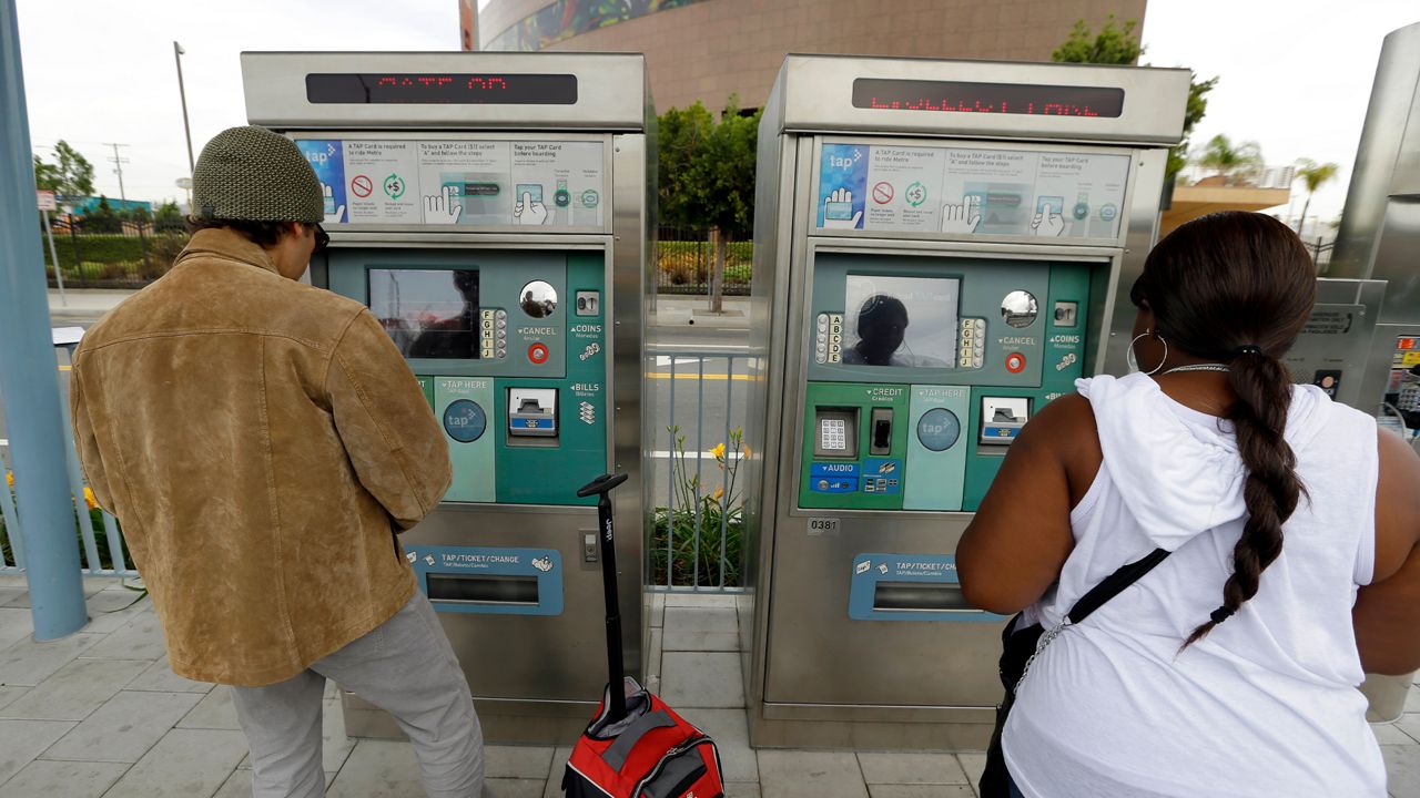 Passengers pay for TAP (Transit Access Pass) cards at the Metro Expo/Crenshaw station in Los Angeles' Crenshaw district Tuesday, Jan. 21, 2014. (AP Photo/Reed Saxon)