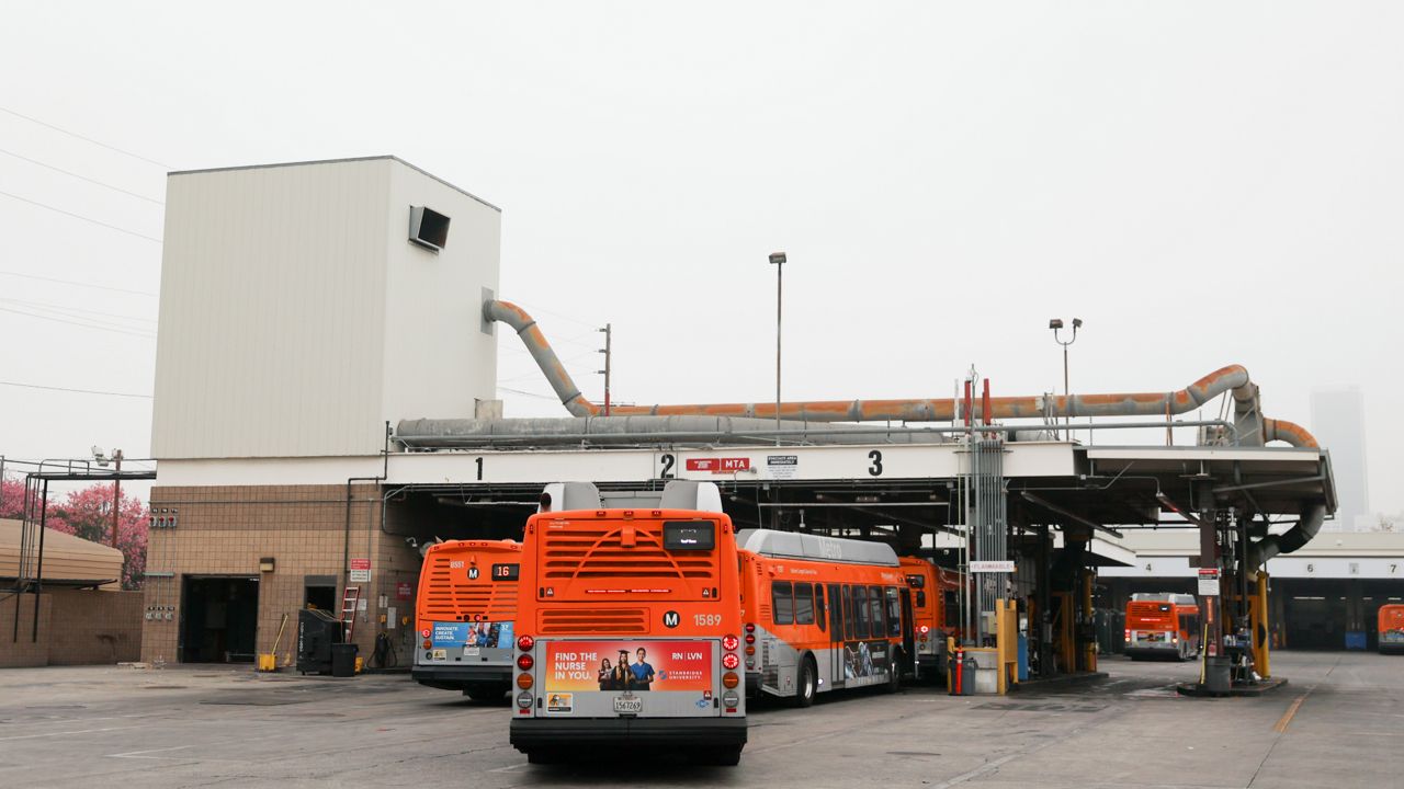 Buses enter a Los Angeles MTA bus depot near the site where overnight a bus was hijacked by an armed subject with passengers on board on Sept. 25, 2024 in Los Angeles. (AP Photo/Ryan Sun)