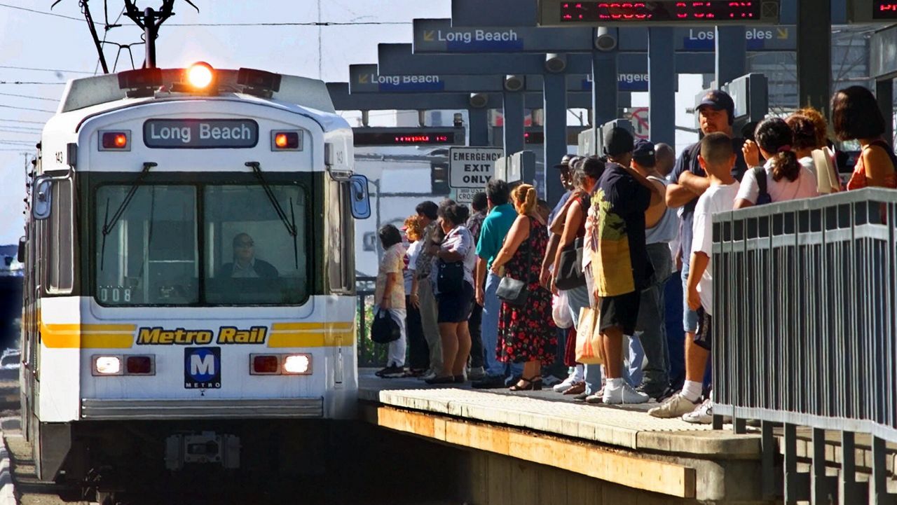 Passengers prepare to board a Long Beach-bound Metro Rail Blue Line train at Washington and Grand near downtown Los Angeles on Thursday, Sept. 14, 2000. With a strike deadline of 12:01 a.m. Friday, three unions representing Metropolitan Transit Authority drivers, mechanics and clerks were still negotiating with the agency Thursday afternoon, trying to avert a shutdown of about 200 bus and three rail routes, inconveniencing an estimated 450,000 daily riders. (AP Photo/Reed Saxon)