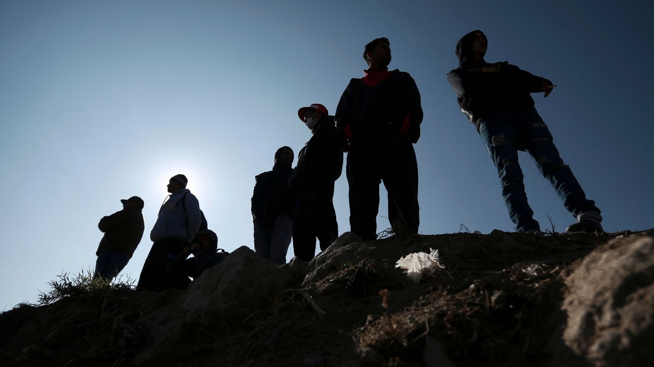 Migrants stand near the U.S.-Mexico border in Ciudad Juarez, Mexico, Dec. 19, 2022. The Supreme Court is keeping pandemic-era limits on people seeking asylum in place indefinitely, dashing hopes of immigration advocates who had been anticipating their end this week. The restrictions, often referred to as Title 42, were put in place under then-President Donald Trump at the beginning of the pandemic to curb the spread of COVID-19. T(AP Photo/Christian Chavez, File)