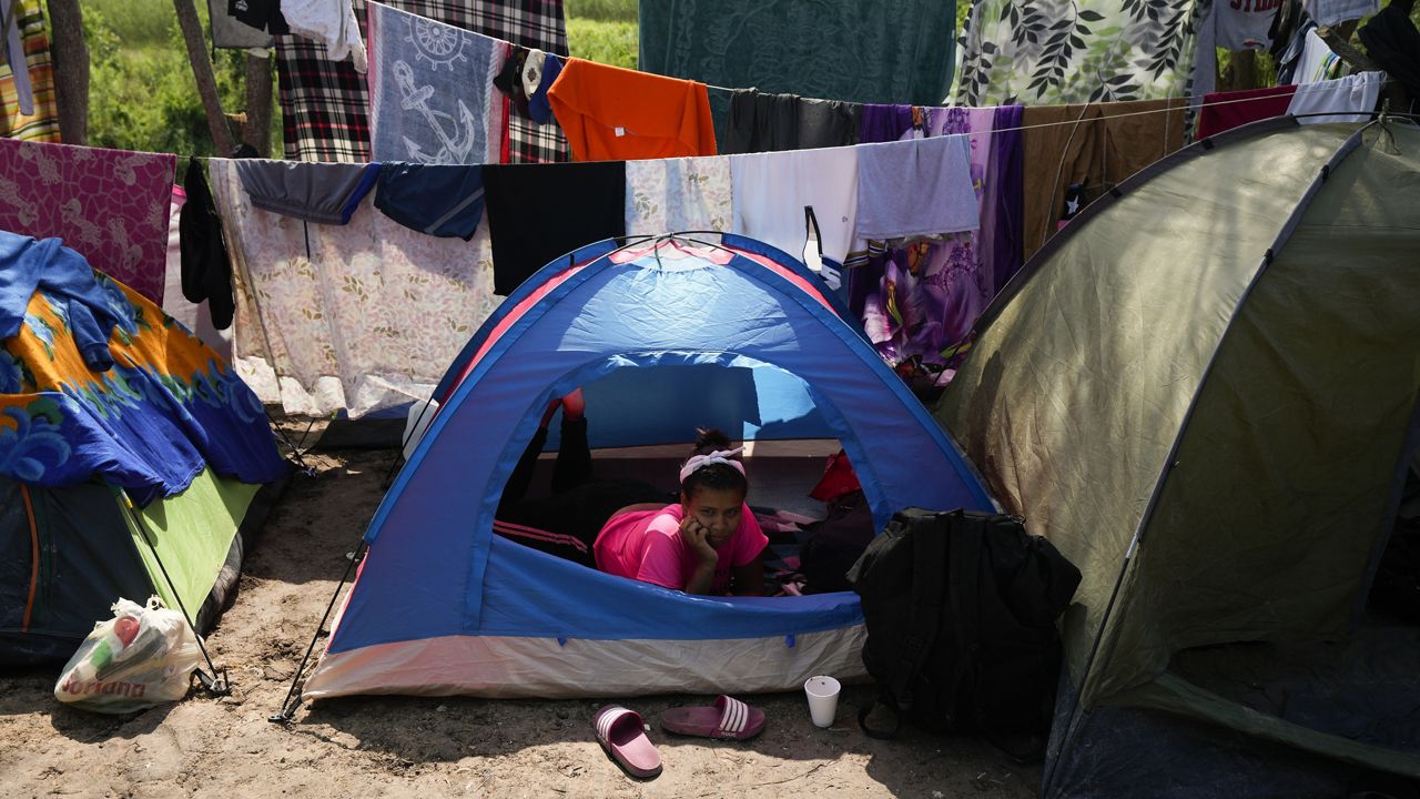 A Venezuelan migrant rests inside her tent on the bank of the Rio Grande in Matamoros, Mexico, on Sunday, May 14, 2023. (AP Photo/Fernando Llano)