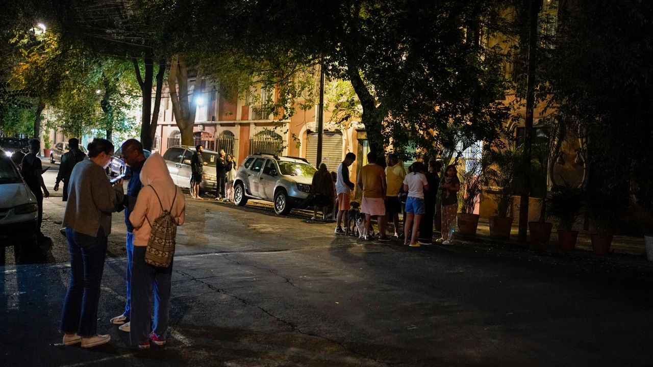 People gather Thursday outside after an earthquake was felt in Mexico City. (AP Photo/Eduardo Verdugo)