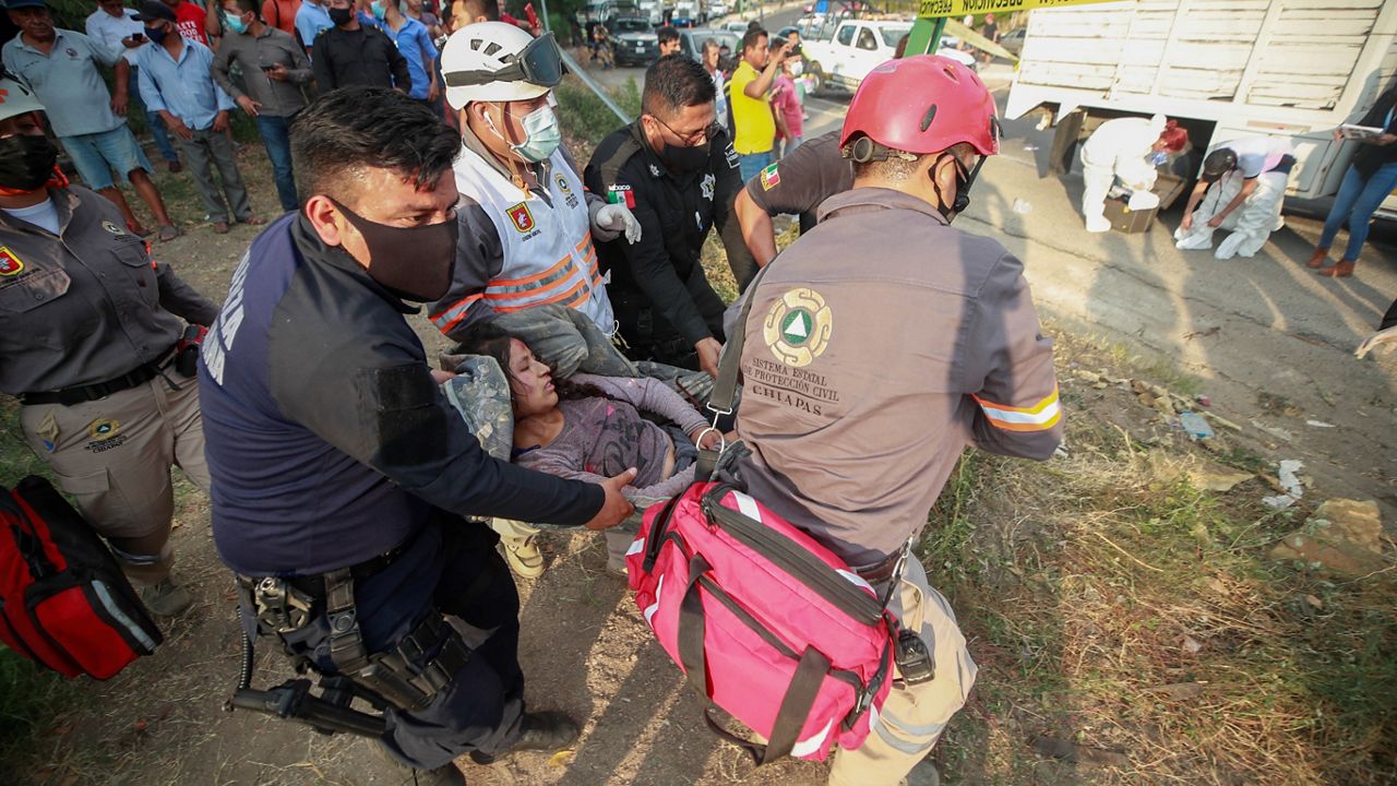 An injured migrant woman is moved by rescue personnel from the site of an accident near Tuxtla Gutierrez, Chiapas state, Mexico, Thursday, Dec. 9, 2021. (AP Photo)