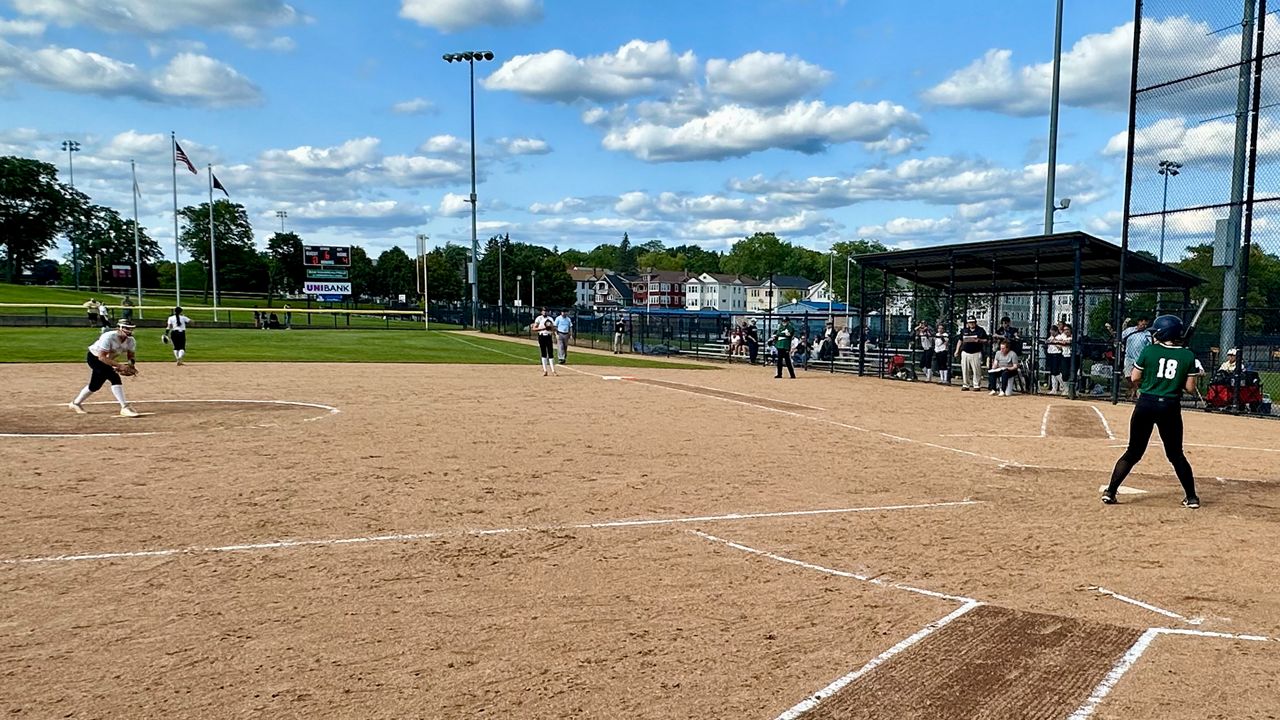 st paul and marshfield softball teams play a game on a sunny day