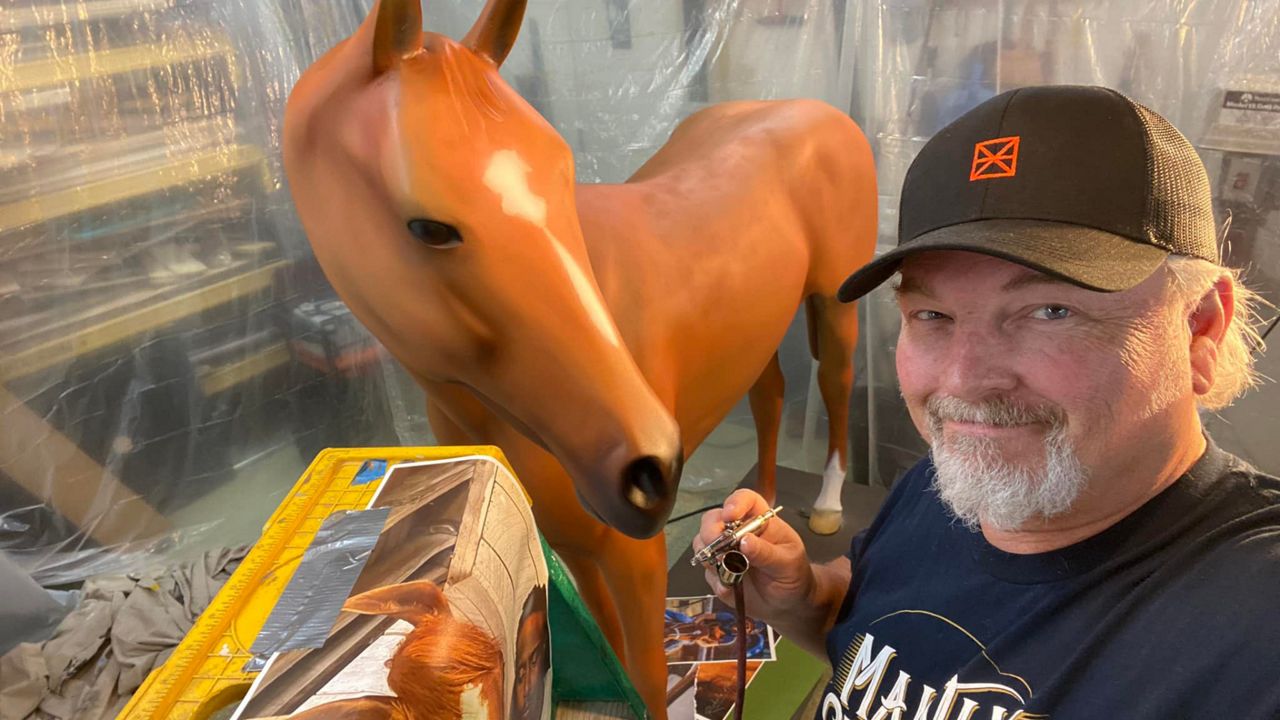 Louisville artist Michael Prather airbrushes a replica of Derby 148 winner Rich Strike which will be on display at the Museum's Winner Circle. (Kentucky Derby Museum)