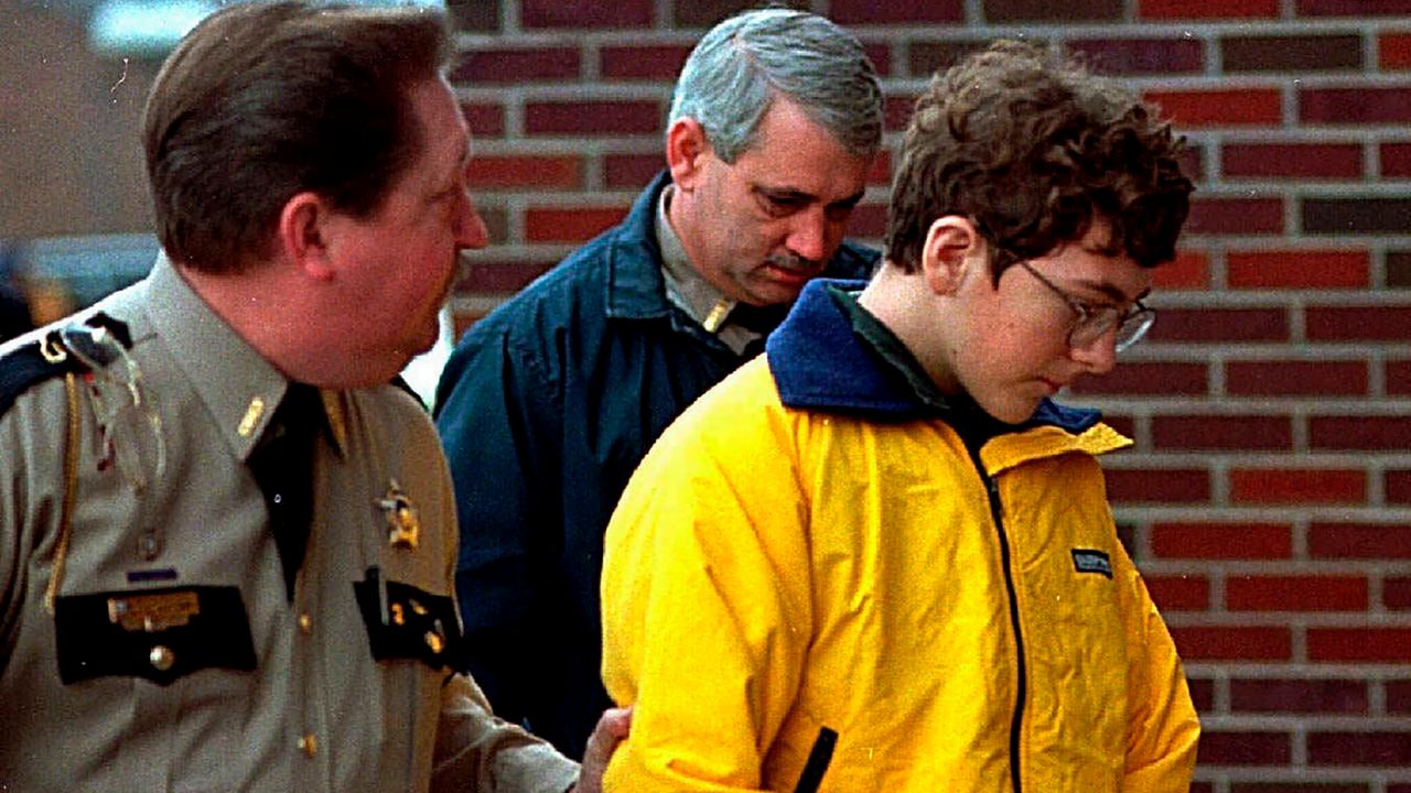 Heath High School shooting suspect Michael Carneal is escorted out of the McCracken County Courthouse after his arraignment in Paducah, Ky., Jan. 15, 1998. Carneal was accused of opening fire inside a Kentucky high school, killing three classmates and wounding five others Dec. 1, 1997. In the quarter century that has passed, school shootings have become a depressingly regular occurrence in the U.S. (Courier Journal via AP/Sam Upshaw Jr.)