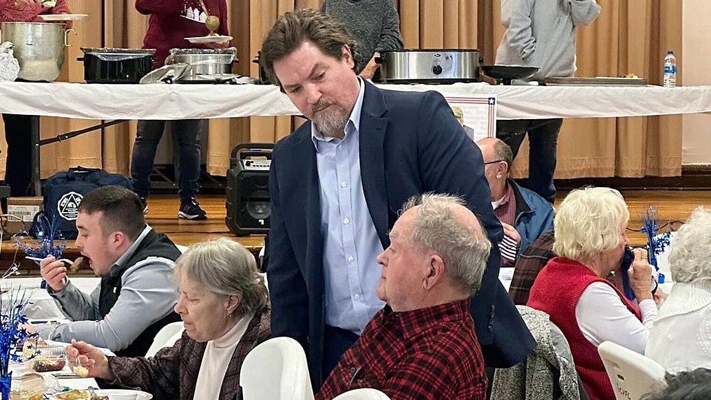 Michael Kripchak, standing, meets with supporters on Feb. 18, 2024, at the Monroe County, Ohio, Democratic Party, Pre-Primary Baked Steak Dinner. Kripchak’s loss in the 6th Congressional District race to two-term Republican state Sen. Michael Rulli was narrower than expected. (Committee to Elect Michael Kripchak via AP)