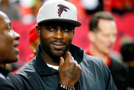 Former Atlanta Falcons quarterback Michael Vick stands on the sidelines before an NFL football game between the Falcons and the New Orleans Saints in Atlanta. (AP Photo/John Bazemore, File)