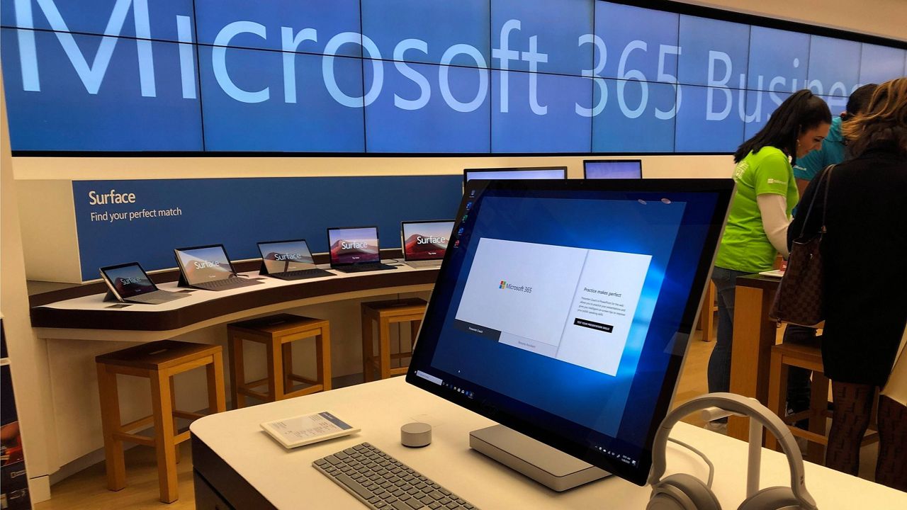 A Microsoft computer is among items displayed at a Microsoft store in suburban Boston. (AP Photo/Steven Senne, File)