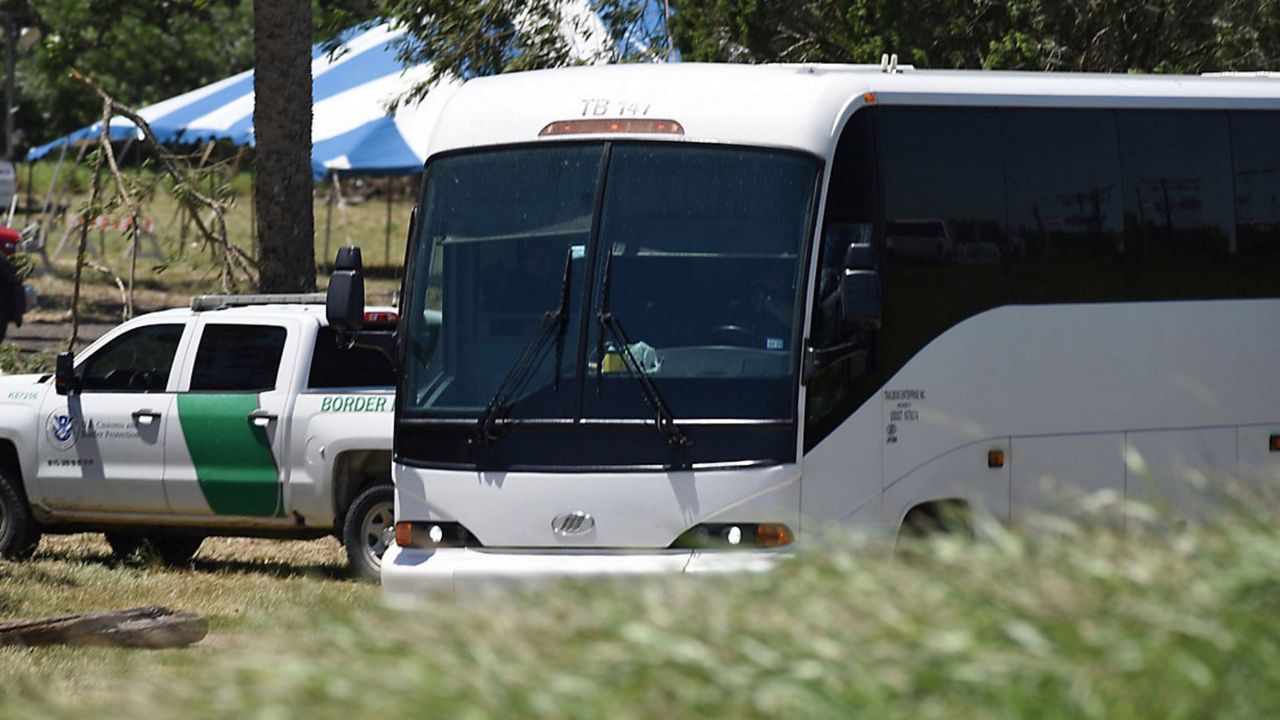 A Border Patrol vehicle and bus are parked near a staging area near the U.S.-Mexico border in Brownsville, Texas, Saturday, April 29, 2023. (AP Photo/Valerie Gonzalez)