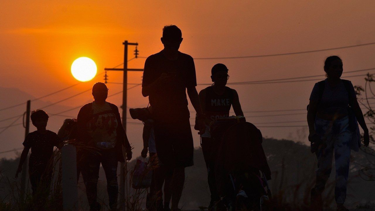 Migrants walk at sunrise along the highway through Arriaga, Chiapas state in southern Mexico, Monday, Jan. 8, 2024, during their journey north toward the U.S. border. (AP Photo/Edgar H. Clemente)