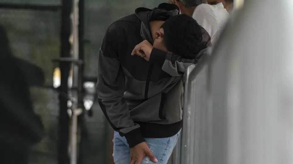 A migrant waits at the Gateway International Port of Entry under U.S. Customs and Border Protection custody in Brownsville, Texas, Friday, May 5, 2023, before being sent back to Mexico under Title 42. (AP Photo/Veronica G. Cardenas)