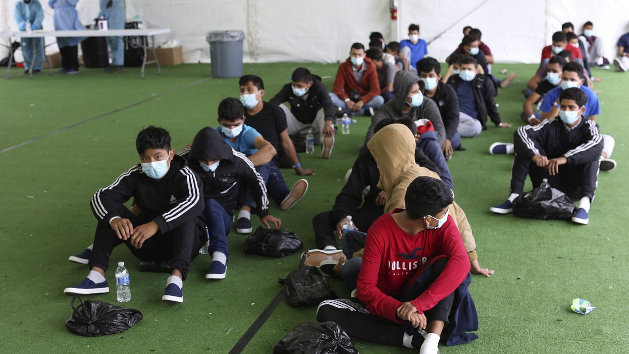 In this March 30 file photo, young migrants wait to be tested for COVID-19 at the Donna Department of Homeland Security holding facility in Donna, Texas. (AP Photo/Dario Lopez-Mills, Pool, File)