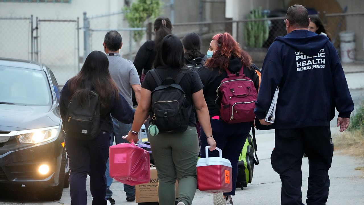 Los Angeles County Public Health Emergency Operations officials leave St. Anthony's Croatian Catholic Church after evaluating newly arrived migrants being housed in the Chinatown area of Los Angeles on Wednesday, June 14, 2023. A group of migrants, including some children, who arrived by bus from Texas, were dropped off at Union Station Wednesday and were being cared for at the church. Texas Gov. Greg Abbott said the migrants were sent to Los Angeles because California had declared itself a "sanctuary" for immigrants. (AP Photo/Damian Dovarganes)