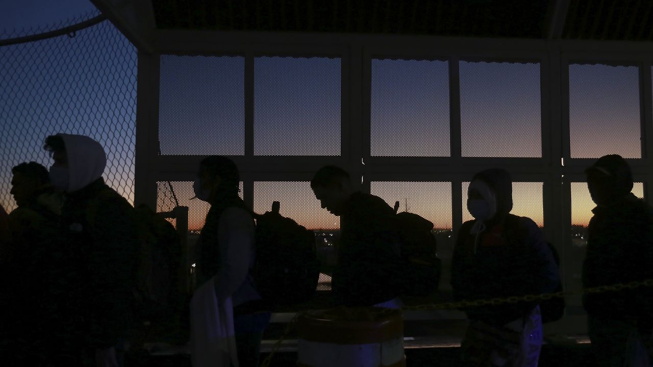 Migrants line up to present to U.S. agents documents requesting appointment to apply for asylum at the Paso del Norte international bridge, in Ciudad Juarez, Mexico, Tuesday Nov 5, 2024. (AP Photo/Christian Chavez)