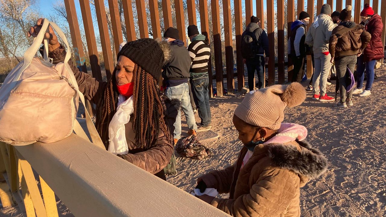 A Cuban woman and her daughter wait in line to be escorted to a Border Patrol van for processing in Yuma, Ariz., on Feb. 6. They hoped to remain in the United States to seek asylum. (AP Photo/Elliot Spagat, File)