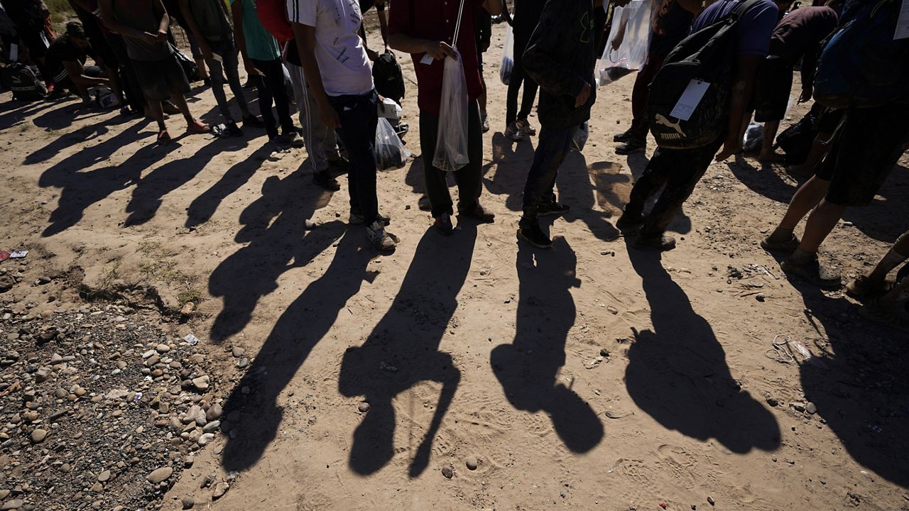 Migrants wait to be processed by the U.S. Customs and Border Patrol after they crossed the Rio Grande and entered the U.S. from Mexico, Oct. 19, 2023, in Eagle Pass, Texas.