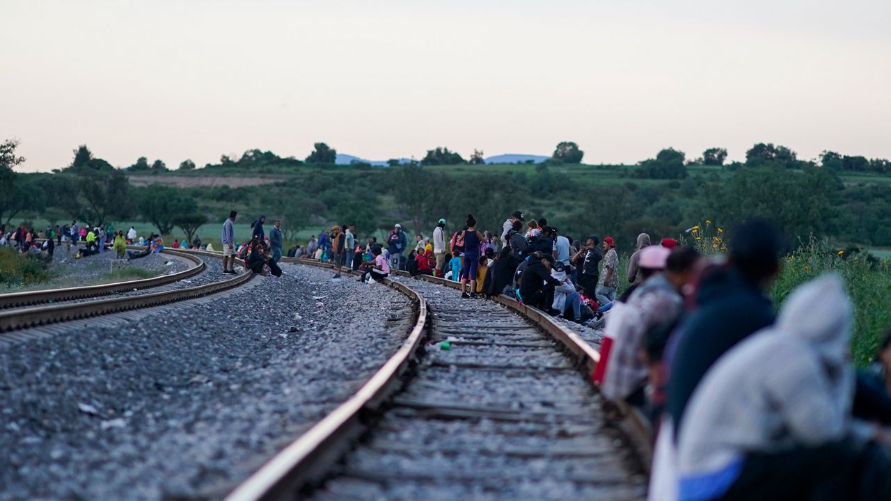 Migrants wait along rail lines hoping to board a freight train heading north, one that stops long enough so they can hop on, in Huehuetoca, Mexico, Sept. 19, 2023. Ferromex, Mexico's largest railroad company announced that it was suspending operations of its cargo trains due to the massive number of migrants that are illegally hitching a ride on its trains moving north towards the U.S. border. (AP Photo/Eduardo Verdugo)