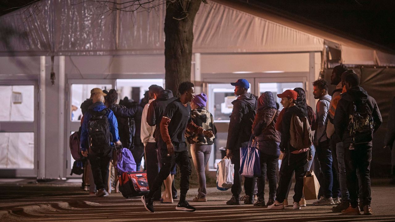 Migrants queue to enter the migrant shelter on Randall's Island, April 9, 2024, in New York. (AP Photo/Andres Kudacki, File)