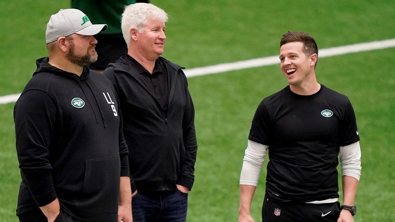 New York Jets' offensive coordinator Mike LaFleur, right, speaks with general manager Joe Douglas, left, as players practice during the NFL football team's training camp, Friday, May 6, 2022, in Florham Park, N.J. (AP Photo/John Minchillo, File)