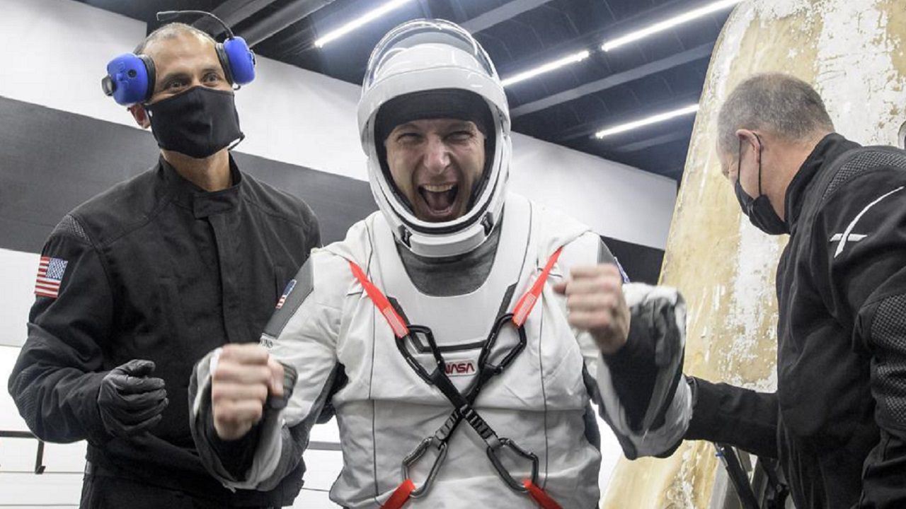 NASA astronaut Mike Hopkins is helped out of the SpaceX Crew Dragon Resilience spacecraft onboard the SpaceX GO Navigator recovery ship after he, NASA astronauts Mike Hopkins, Shannon Walker, and Japan Aerospace Exploration Agency (JAXA) astronaut Soichi Noguchi, landed in the Gulf of Mexico off the coast of Panama City, Florida, Sunday. (NASA TV via AP)