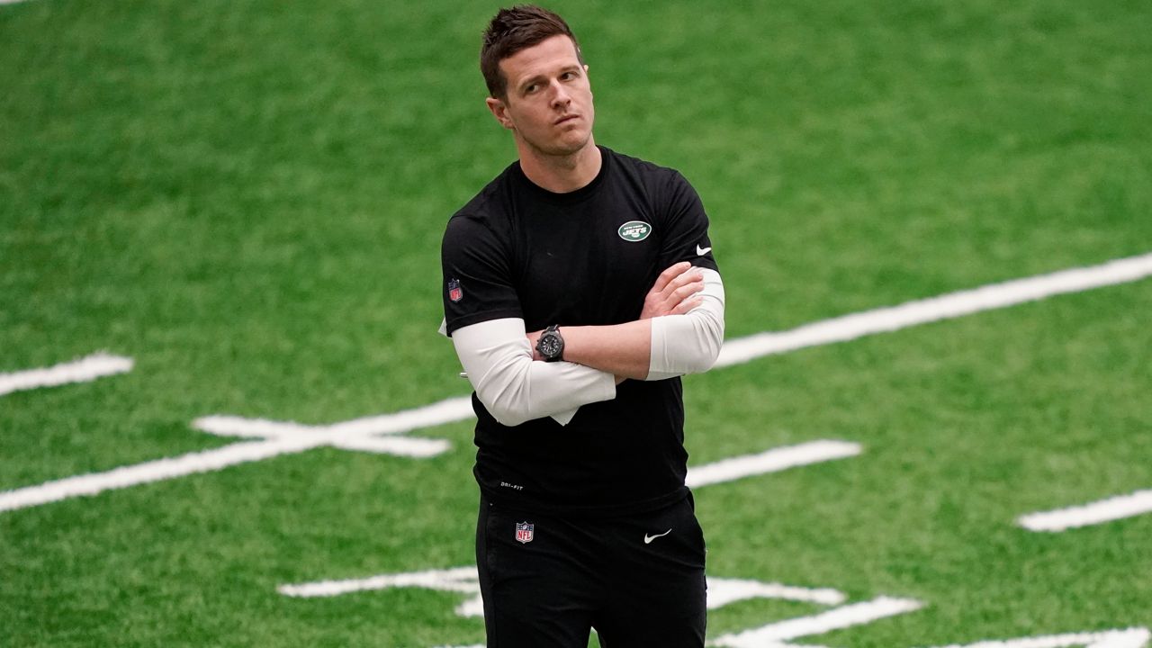 New York Jets offensive coordinator Mike LaFleur stands on the field as players practice during the NFL football team's training camp May 6, 2022, in Florham Park, N.J. (AP Photo/John Minchillo, File)